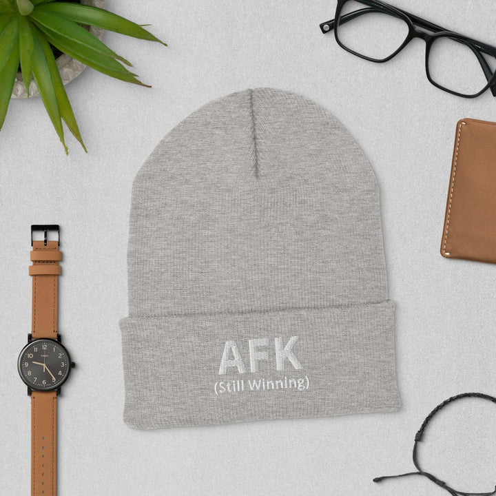 AFK Cuffed Beanie displayed with accessories including a watch and eyeglasses on a flat surface.