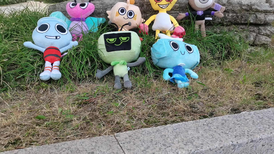 Colorful plush stuffed animals arranged on grass, perfect for home decoration and children's gifts.