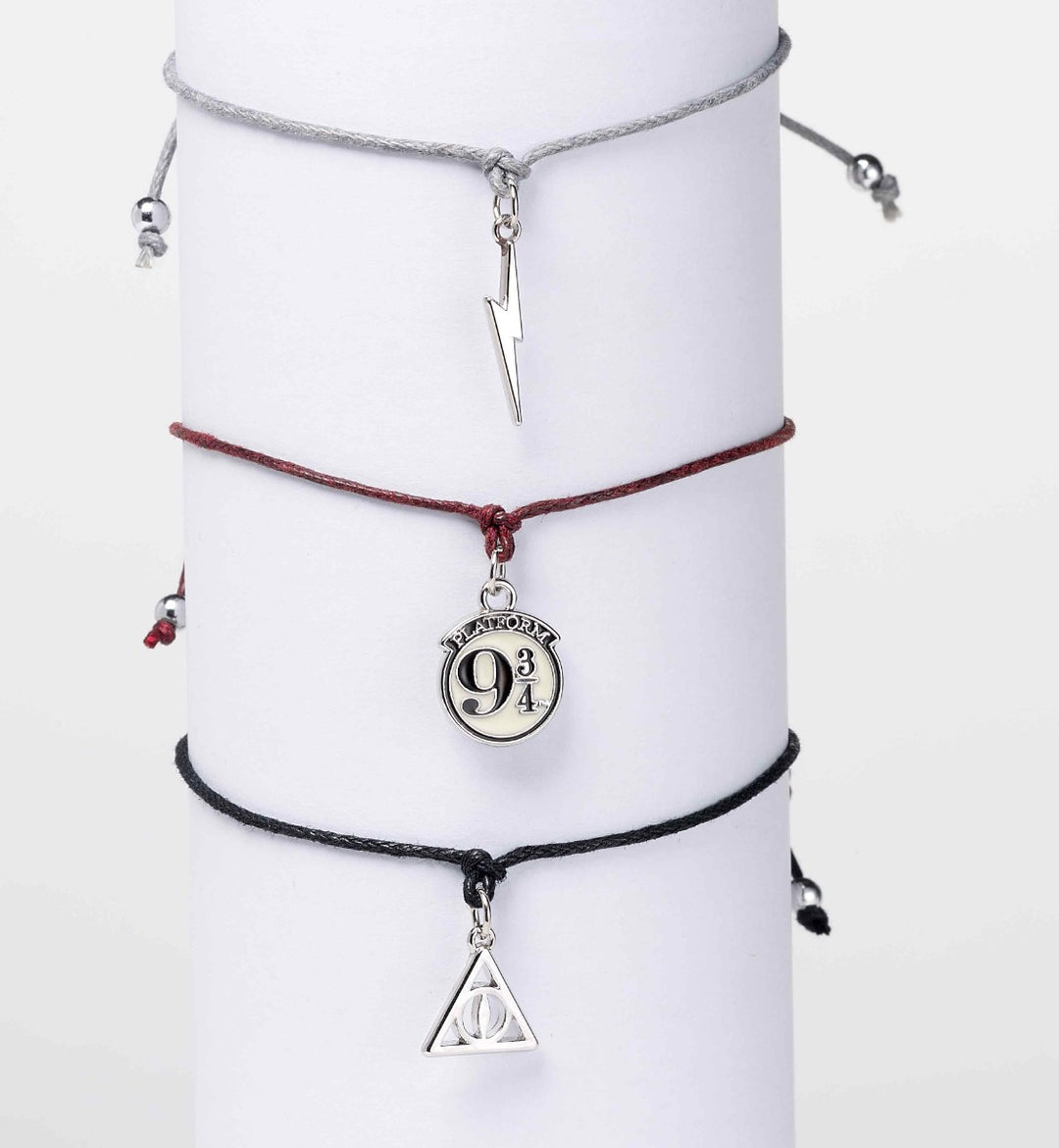 Harry Potter friendship bracelet set featuring charms of Platform 9 3/4, Lightning Bolt, and Deathly Hallows.