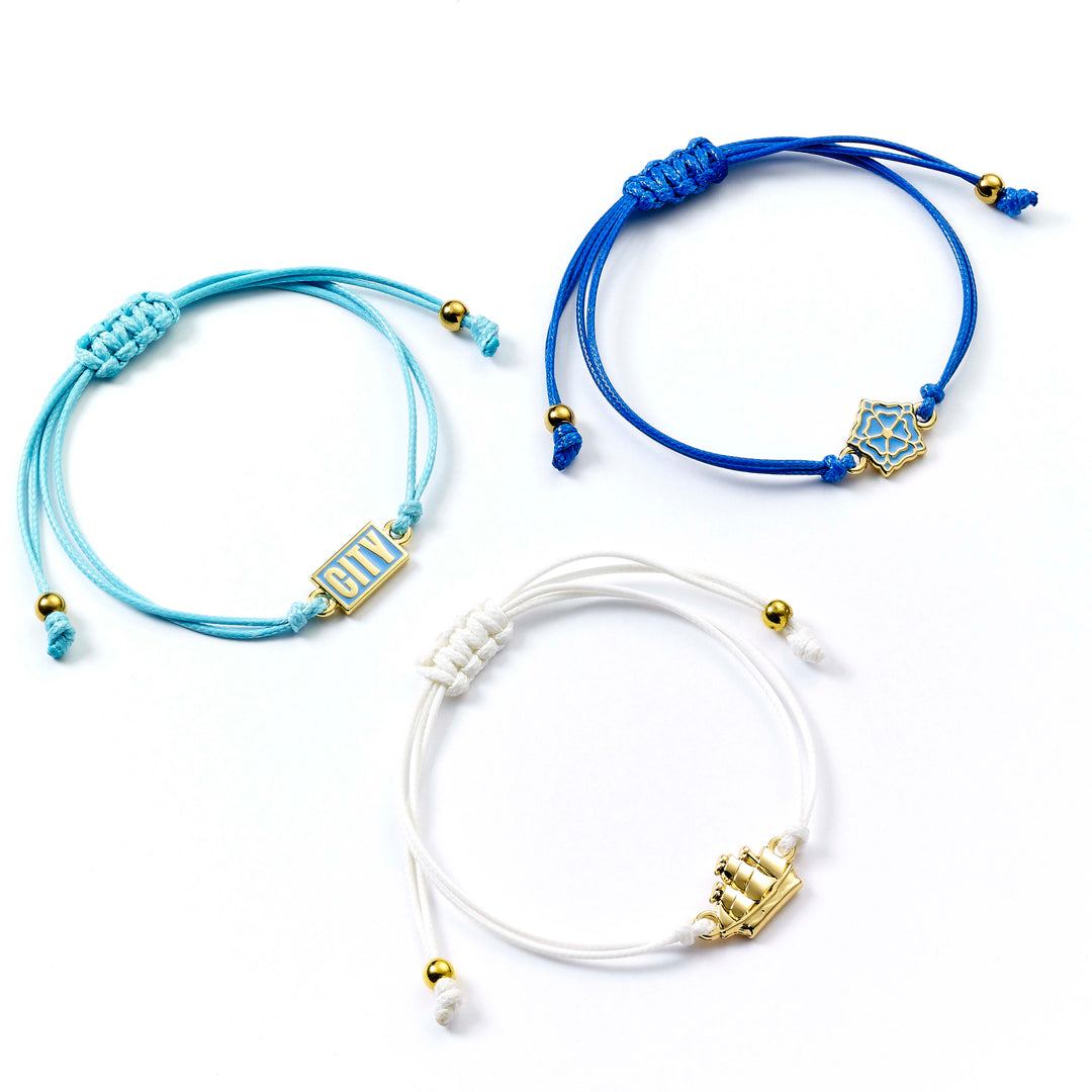 Manchester City friendship bracelet set featuring adjustable cord bracelets in blue and white with team emblems.