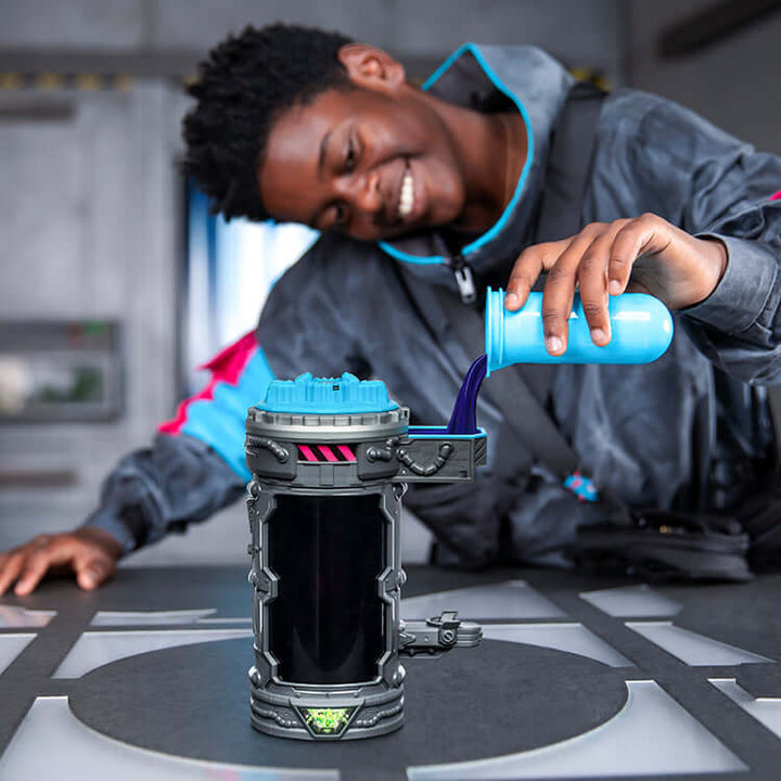Child experimenting with the MrBeast Lab Mutators Chamber - Metallic Panther, pouring liquid into the action figure chamber.