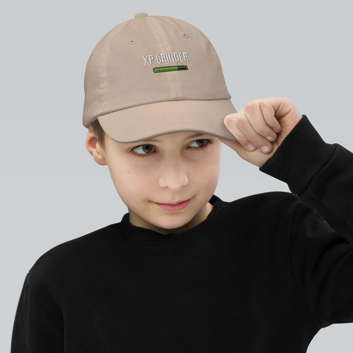 Boy wearing an XP Grinder Youth baseball cap, showcasing its stylish design and comfort.